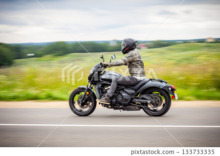 motorbike on the road riding. having fun driving the empty road on a motorcycle tour journey. copyspace for your individual text. Fast Motion Blur effect 133733335