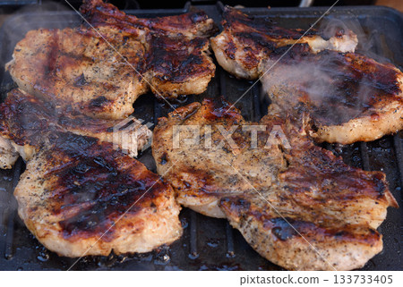 Pork steaks, on the bone, grilled, smoke Pork steaks, on the bone, grilled, smoke 133733405