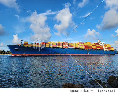 Cargo ship Maersk Puelo with container in Miami. Freight container loaded on cargo vessel in Miami. Aerial view cargo ship entering harbor. Container ship 133733481