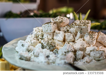 Greek feta cubes with herbs and spices, diced soft cheese isolated on white background with clipping path Greek feta cubes with herbs and spices, diced soft cheese isolated on white background with clipping path 133733508