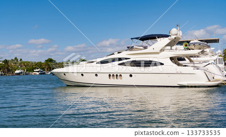 Boating and yachting tourism. Luxurious lifestyle. Vacation on summer. Docked yacht at private area. Sea vacation on summer. Luxury boat motor yacht in marina. Luxury yacht, copy space Boating and yachting tourism. Luxurious lifestyle. Vacation on summer. Docked yacht at private area. Sea vacation on summer. Luxury boat motor yacht in marina. Luxury yacht, copy space 133733535