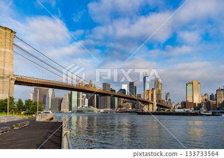 Architecture of historic bridge in Brooklyn. Way to Manhattan. Brooklyn bridge in New York. Manhattan cityscape. Amazing scenery of Brooklyn bridge over skyscraper in New York. NY city 133733564