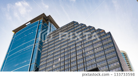 Architecture of modern business office building. Perspective city skyscraper. Business skyscraper building. Architectural building. Glass skyscraper. City architecture. Low angle perspective 133733598