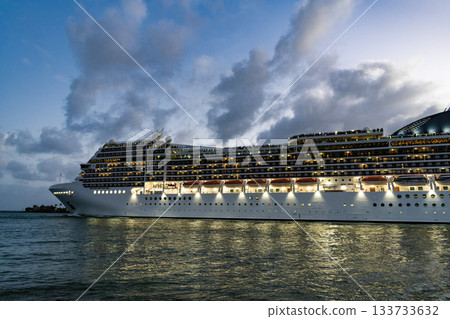 Majestic cruise ship in vacation summer. Cruise ship vacation and travel at sea. View of illuminated luxury liner. Ship at night port. Luxury sea vacation. Cruise ship vacation. Mood and Vibes Majestic cruise ship in vacation summer. Cruise ship vacation and travel at sea. View of illuminated luxury liner. Ship at night port. Luxury sea vacation. Cruise ship vacation. Mood and Vibes 133733632
