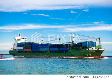Miami, Florida, USA - June 06, 2024: Cargo ship Maersk Puelo with container in Miami. Freight container loaded on cargo vessel in Miami. Aerial view cargo ship entering harbor. Container ship. 133733633