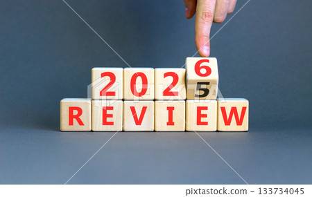 2026 Review symbol. Concept words 2026 Review on beautiful wooden blocks. Beautiful grey paper background. Businessman's hand. Business and 2026 review concept. Copy space. 2026 Review symbol. Concept words 2026 Review on beautiful wooden blocks. Beautiful grey paper background. Businessman's hand. Business and 2026 review concept. Copy space. 133734045