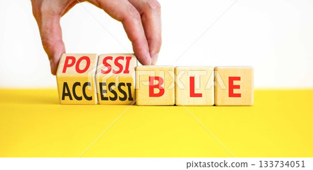 Accessible or possible symbol. Concept words Accessible or Possible on beautiful wooden blocks. Beautiful white background. Doctor's hand. Business accessible or possible concept. Copy space. 133734051