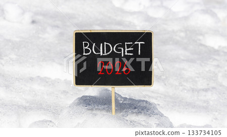 Budget 2026 symbol. Concept words Budget 2026 on beautiful black blackboard. Beautiful white snow background. Business and budget 2026 concept. Copy space. 133734105