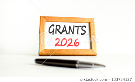 Grants 2026 symbol. Concept words Grants 2026 on beautiful wooden picture frame. Beautiful white paper background. Beautiful black pen. Business and grants 2026 concept. Copy space. 133734127