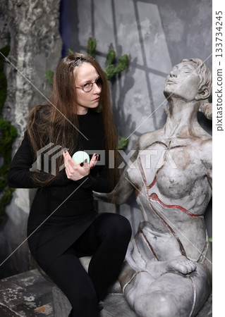 Model in formal attire with artistic set design and lighting 133734245