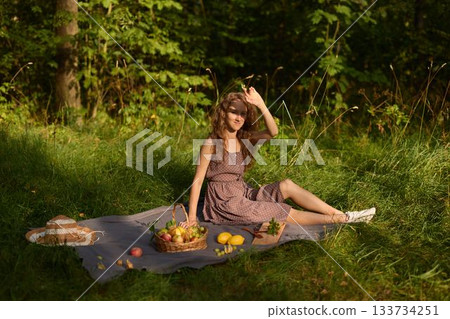 Casual artist seated among seasonal fruits and straw hat Casual artist seated among seasonal fruits and straw hat 133734251