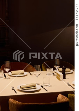 intimate restaurant nook beautifully arranged with sophisticated place settings and cozy ambiance intimate restaurant nook beautifully arranged with sophisticated place settings and cozy ambiance 133734265
