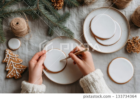 Cozy holiday kitchen vibes: flour-dusted hands knead dough, surrounded by natural greens and wooden textures 133734364