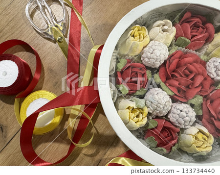 Homemade marshmallow in a hat box with transparent lid, Marshmallow flowers, tulips and roses, Packaging ribbons nearby Homemade marshmallow in a hat box with transparent lid, Marshmallow flowers, tulips and roses, Packaging ribbons nearby 133734440