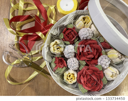 Homemade marshmallow in a hat box, Marshmallow flowers, tulips and roses, Packaging ribbons lie on the table nearby Homemade marshmallow in a hat box, Marshmallow flowers, tulips and roses, Packaging ribbons lie on the table nearby 133734450