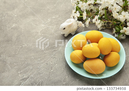 Easter eggs and spring flowers on grey concrete background. Easter eggs and spring flowers on grey concrete background. 133734938