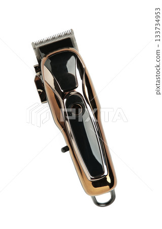A trimmer razor for cutting and modeling hair lies isolated on white background. Electric shaver for barbershop. A trimmer razor for cutting and modeling hair lies isolated on white background. Electric shaver for barbershop. 133734953