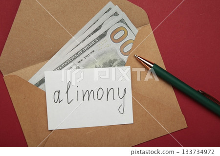 Envelope with word Alimony and money on red background. Envelope with word Alimony and money on red background. 133734972