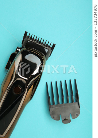 Hair clipper on blue background. Modern hair clipper. Vertical photo Hair clipper on blue background. Modern hair clipper. Vertical photo 133734976