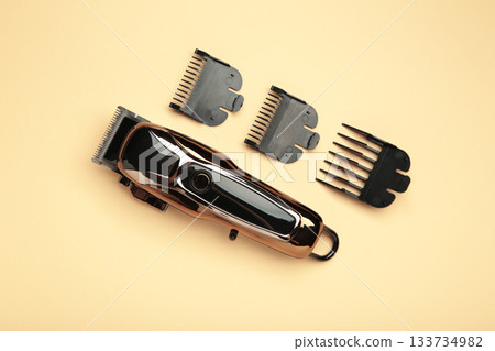 Hair clipper on beige background. Modern hair clipper. Hair clipper on beige background. Modern hair clipper. 133734982