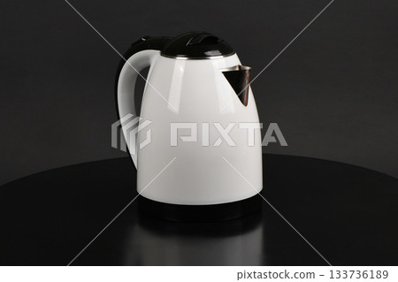 Modern White and Black Electric Kettle on Dark Surface Modern White and Black Electric Kettle on Dark Surface 133736189