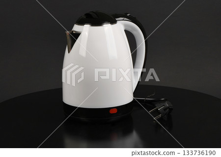 Modern White and Black Electric Kettle on Dark Surface Modern White and Black Electric Kettle on Dark Surface 133736190