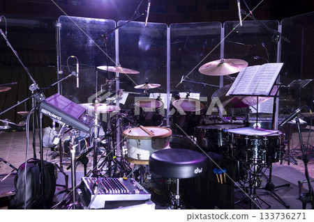 Drum kit on stage before a concert behind a screen Drum kit on stage before a concert behind a screen 133736271