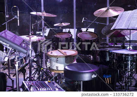 Drum kit on stage before a concert behind a screen Drum kit on stage before a concert behind a screen 133736272