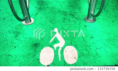 Green bike parking spot marking on asphalt 133736356