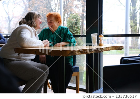 cafe drinking coffee woman and adult daughter elderly woman Portrait of old peasant woman with smiling daughter wearing typical Colombian clothes. Women with brown skin. cafe drinking coffee woman and adult daughter elderly woman Portrait of old peasant woman with smiling daughter wearing typical Colombian clothes. Women with brown skin. 133736517