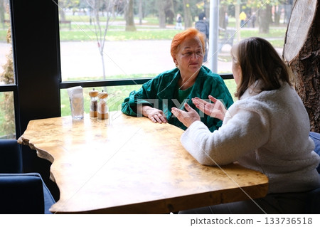 cafe drinking coffee woman and adult daughter elderly woman Portrait of old peasant woman with smiling daughter wearing typical Colombian clothes. Women with brown skin. cafe drinking coffee woman and adult daughter elderly woman Portrait of old peasant woman with smiling daughter wearing typical Colombian clothes. Women with brown skin. 133736518