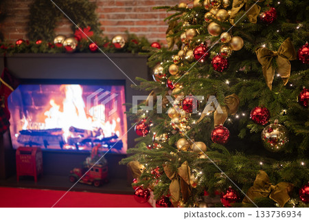 christmas tree for christmas with garland and decorations on blurred bokeh background with a fireplace 133736934
