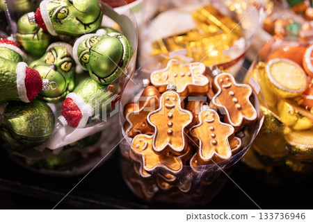 Beautiful Christmas tree decorations and balls are sold in a display case at a Christmas fair 133736946