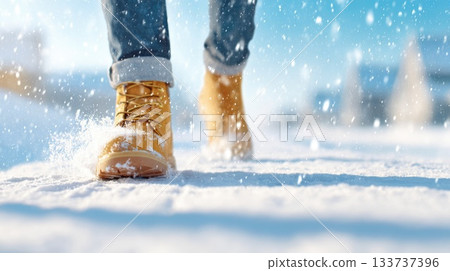 Person Walking Through Fresh Snow in Winter Boots on Sunny Day 133737396