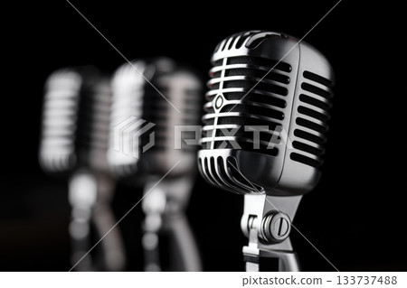 Close-up of retro microphones with black background 133737488