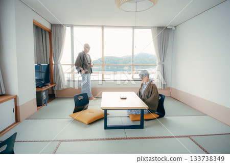 An elderly couple relaxing in a Japanese-style room An elderly couple relaxing in a Japanese-style room 133738349
