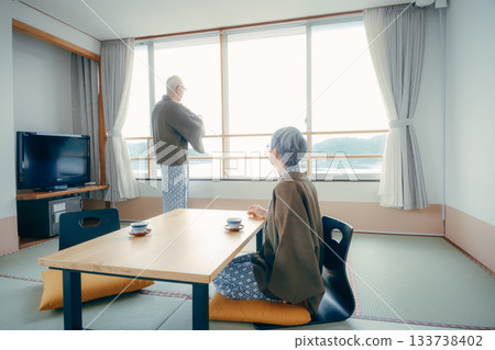 An elderly couple taking pictures of the scenery with their smartphones at a traditional Japanese inn An elderly couple taking pictures of the scenery with their smartphones at a traditional Japanese inn 133738402