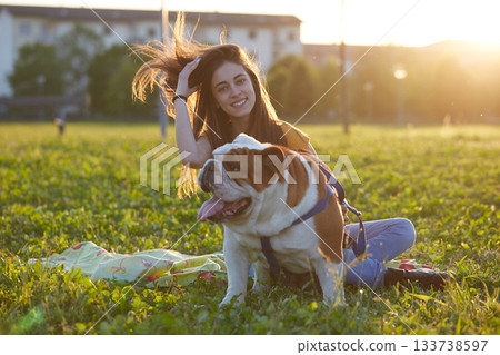 Young brunette girl play with her british bulldog Young brunette girl play with her british bulldog 133738597