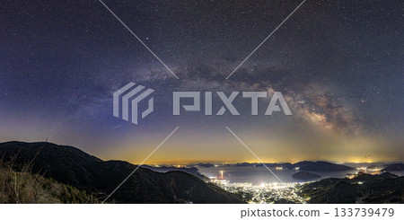Starry sky of the Setouchi in early spring: The Milky Way arch over the port town night view and the beautiful islands Starry sky of the Setouchi in early spring: The Milky Way arch over the port town night view and the beautiful islands 133739479