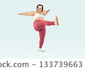 Happy overweight woman doing doing leg swing exercise during her fitness workout 133739663