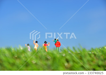 Image of people waving under a blue sky Image of people waving under a blue sky 133740025