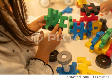 Girl playing block game Girl playing block game 133740354