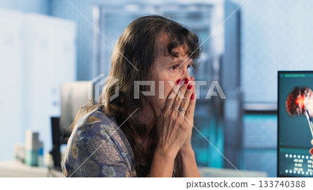 Doctor provides cancer screening guidance to a patient in office, discussing MRI scans and tumor growth. Early detection and preventative medicine are emphasized for better health outcomes. Camera B. 133740388