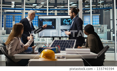 Photovoltaics plant coworkers brainstorming ways to improve solar cells efficiency. Solar panels factory research and development department staff members working on clean energy solutions, camera A 133740394