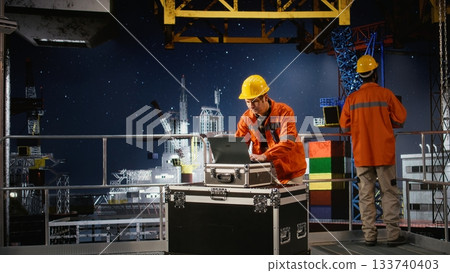 Concerned employee on offshore oil platform manages petroleum extraction using laptop, sweating and struggling to ensure safe oil extraction. Worried restless engineer. 133740403