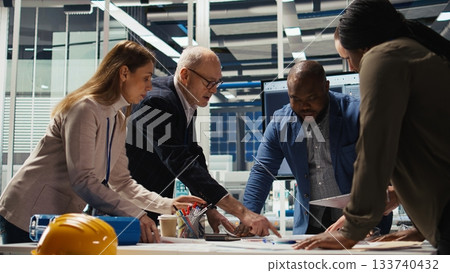 Solar panels plant shareholders talking about business growth and market expansion. Investors meeting with photovoltaics factory managers to discuss ways to improve production, camera A Solar panels plant shareholders talking about business growth and market expansion. Investors meeting with photovoltaics factory managers to discuss ways to improve production, camera A 133740432