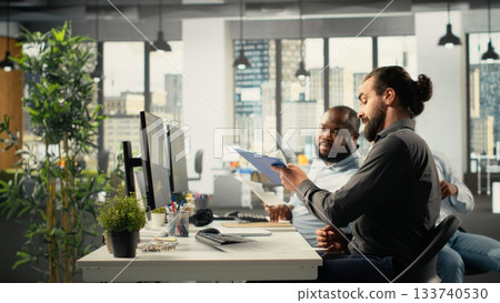 Business staff in modern office sharing insights and reports with colleagues, team focuses on data visualization for efficient resource allocation. Company administration at workplace. 133740530