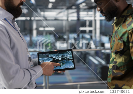 Close up of diverse military personnel in army server farm using AI to enhance threat detection systems and protect the national government secrets. Hybrid warfare mission with high tech. 133740621