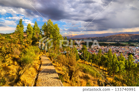 Stone trail leading to the Virgin of the Immaculate Conception statue in Concepcion, Peru. Eucalyptus trees line the path overlooking the town and Andes mountains 133740991