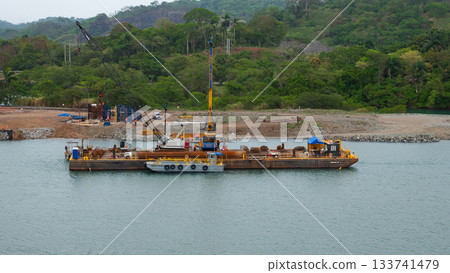 Colon, Panama - May 06, 2019: Water load transportation of barge on river. Cargo barge transport Colon, Panama - May 06, 2019: Water load transportation of barge on river. Cargo barge transport 133741479